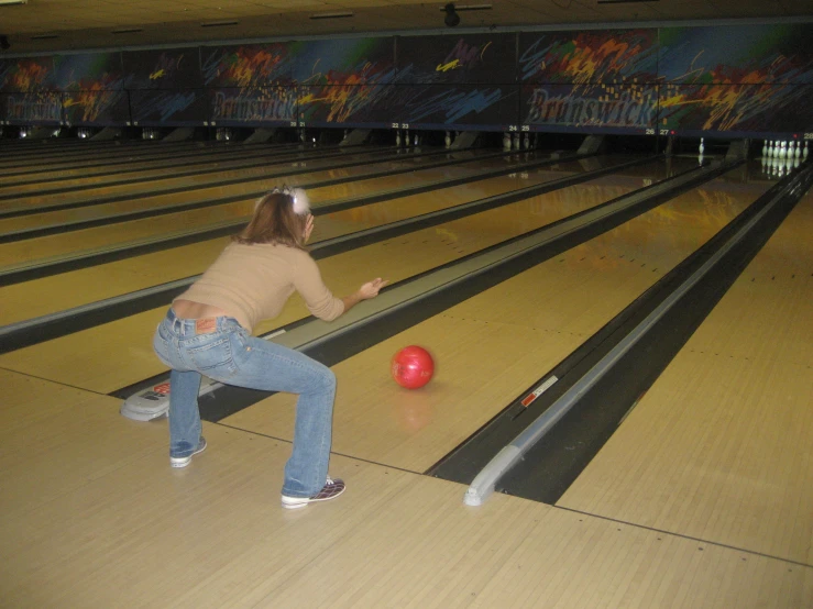 the person is getting ready to bowl the bowling ball
