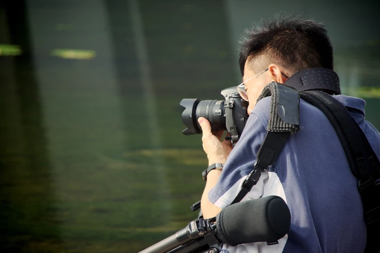 a person holding up a camera to take a po