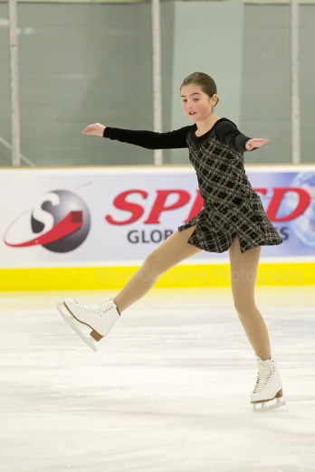 a woman skating on an ice rink with a smile
