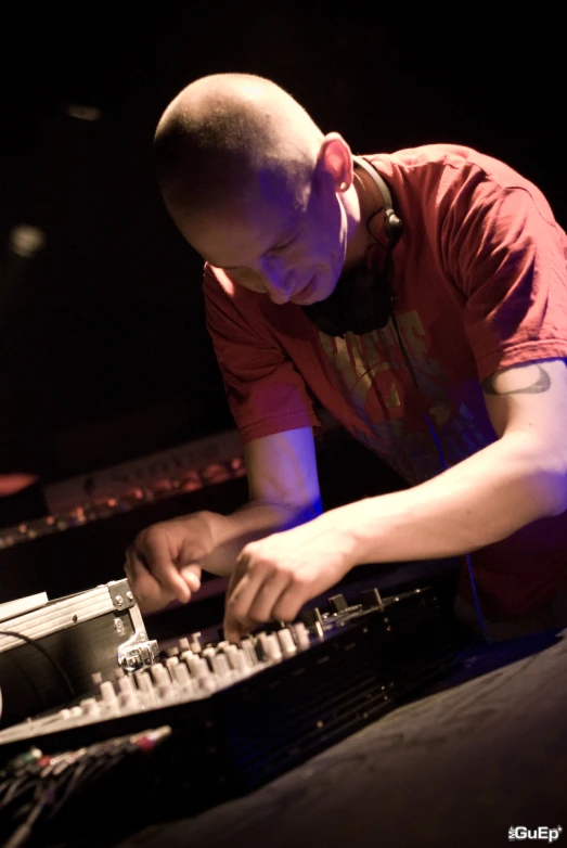 a man with headphones working on a keyboard