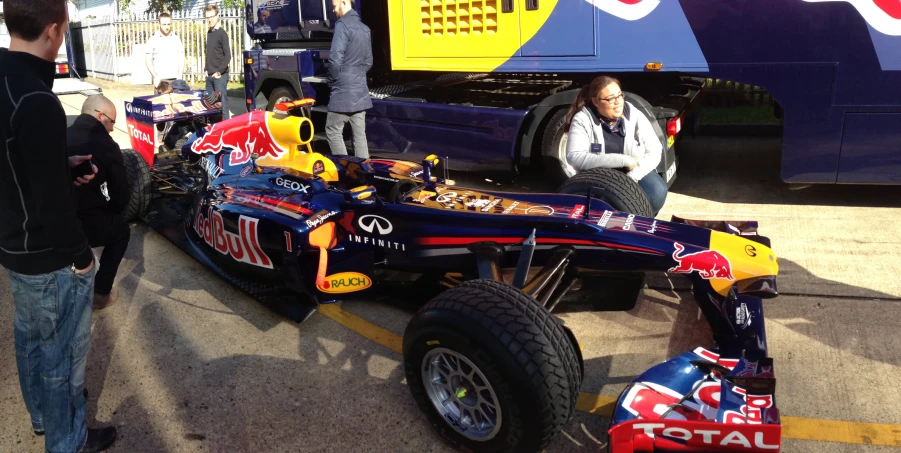 a red bull racing car sits in a parking lot