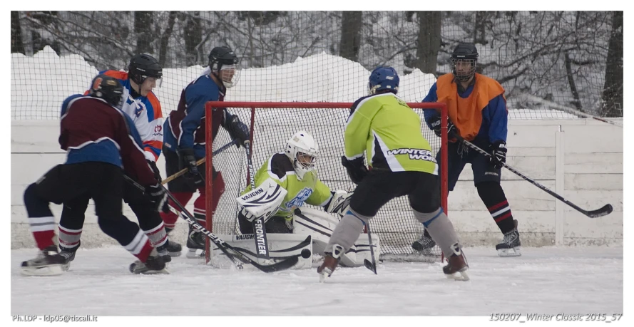 a group of people playing a game of hockey on the ice