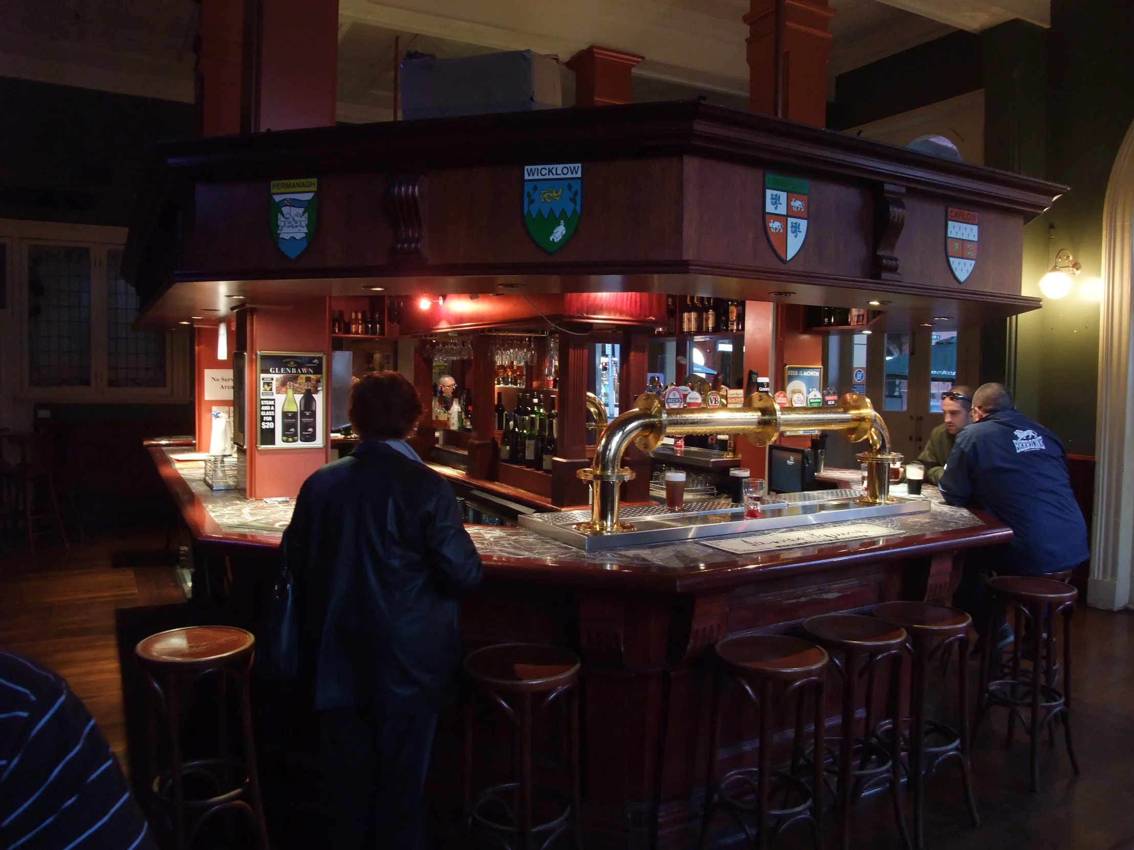 two men in a bar that is dimly lit