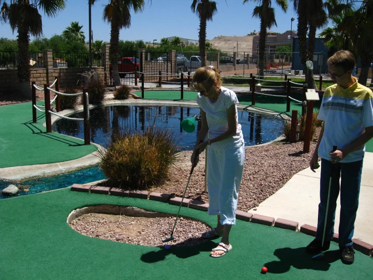 people are playing mini golf in an artificial course