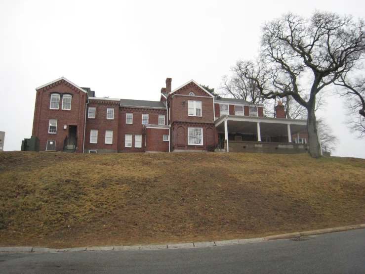 a large, brick house in the fog