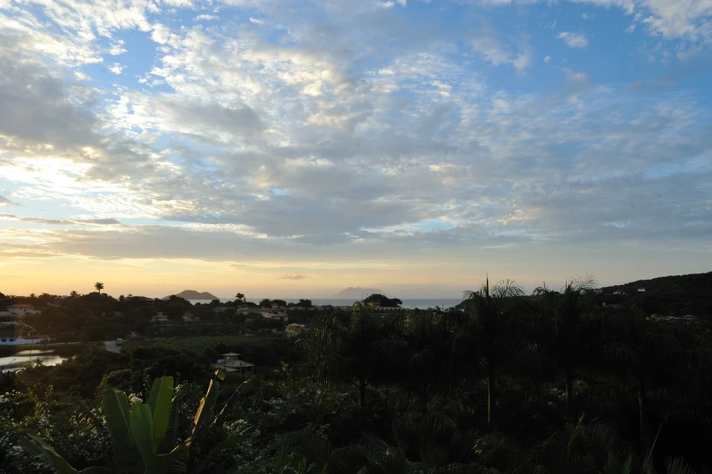 a sunset over the land is seen from the mountain top