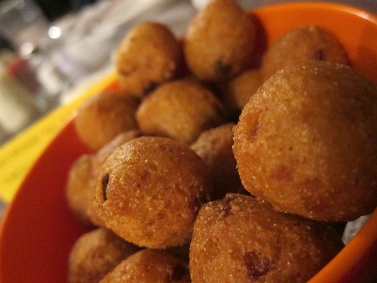 a big bowl filled with some fried balls