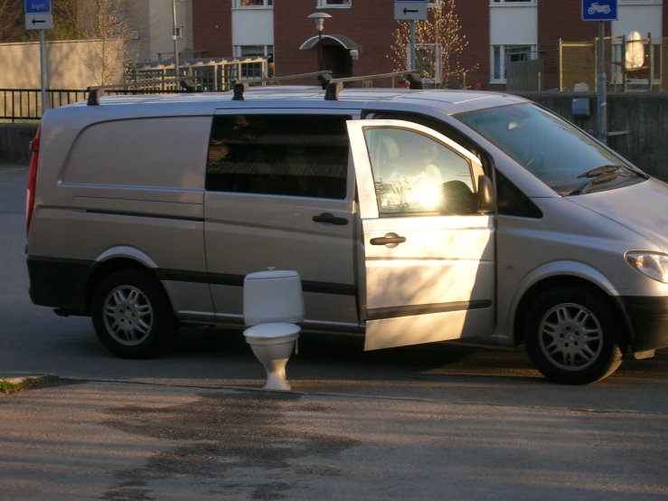 a van has its roof rack extended and is parked outside