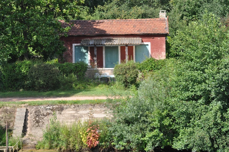 an old brick building sits out across the water