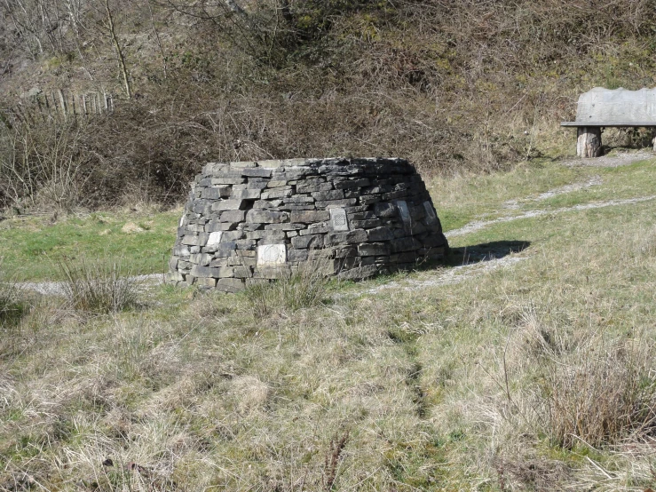 a stone fire place sitting in a field
