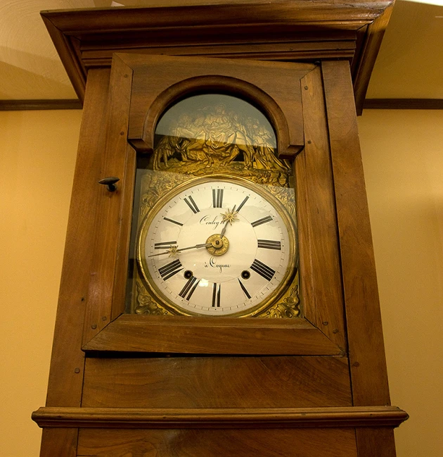 a grandfather clock sitting in the corner of a room