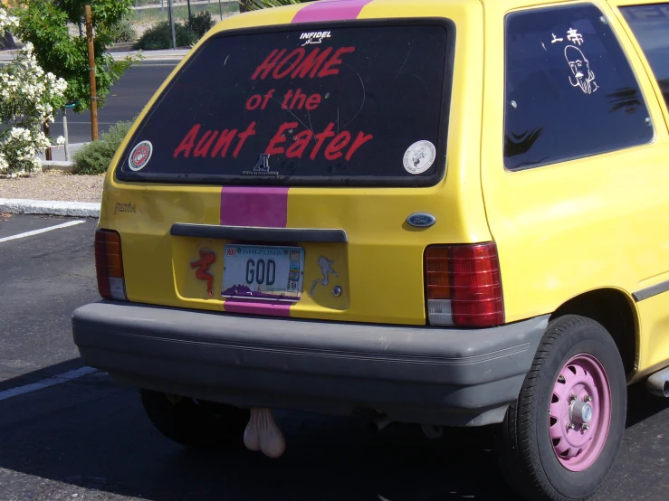 yellow van parked in parking space with advertit on window