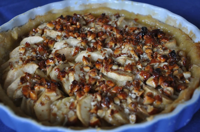 a baked dish is topped with nuts and other things