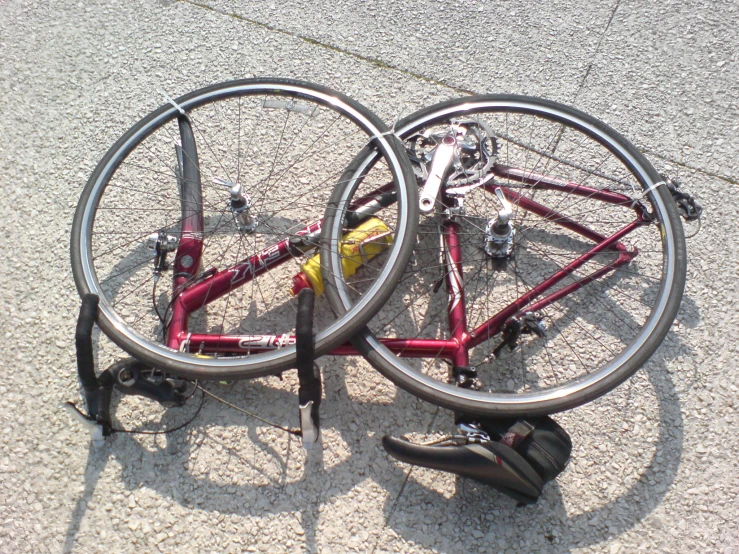 two red bicycles have been knocked apart in a wheel lock position