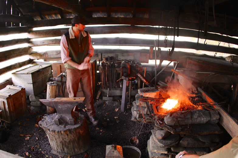 a person in a room with some big pot on fire