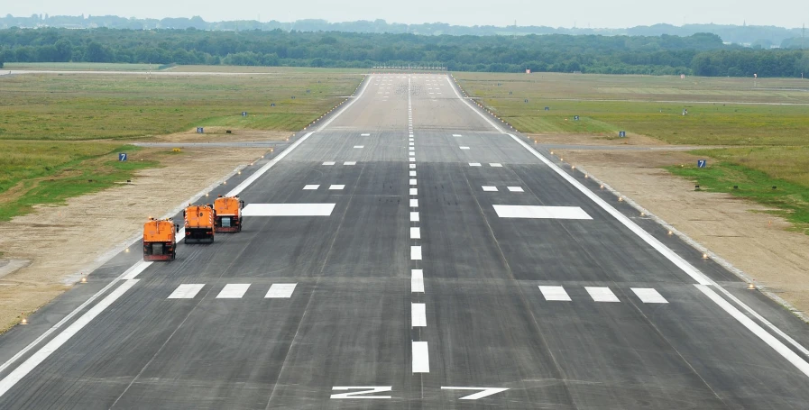 a runway with an airplane taking off from it