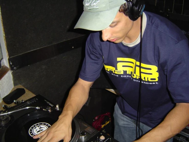 man with headphones mixing in a dj's mixer