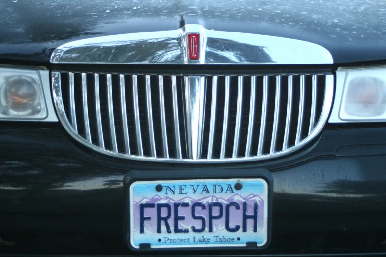 the front bumper of a car with a license plate