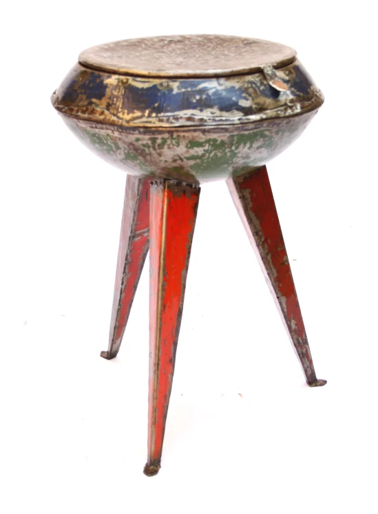 a small metal stool that is red and green