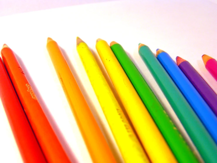a close up of colored pencils in a row