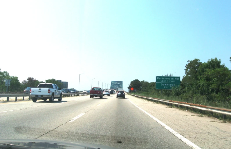 several cars drive down the highway in both directions