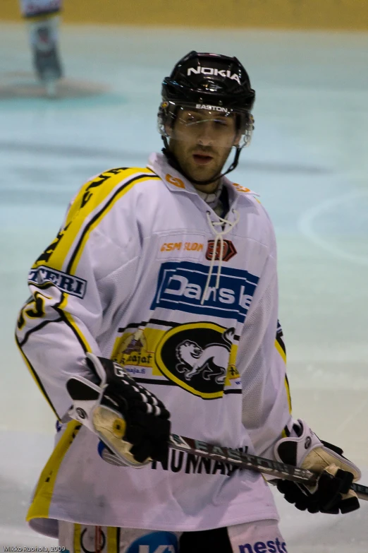 a person holding some hockey stick on a hockey rink