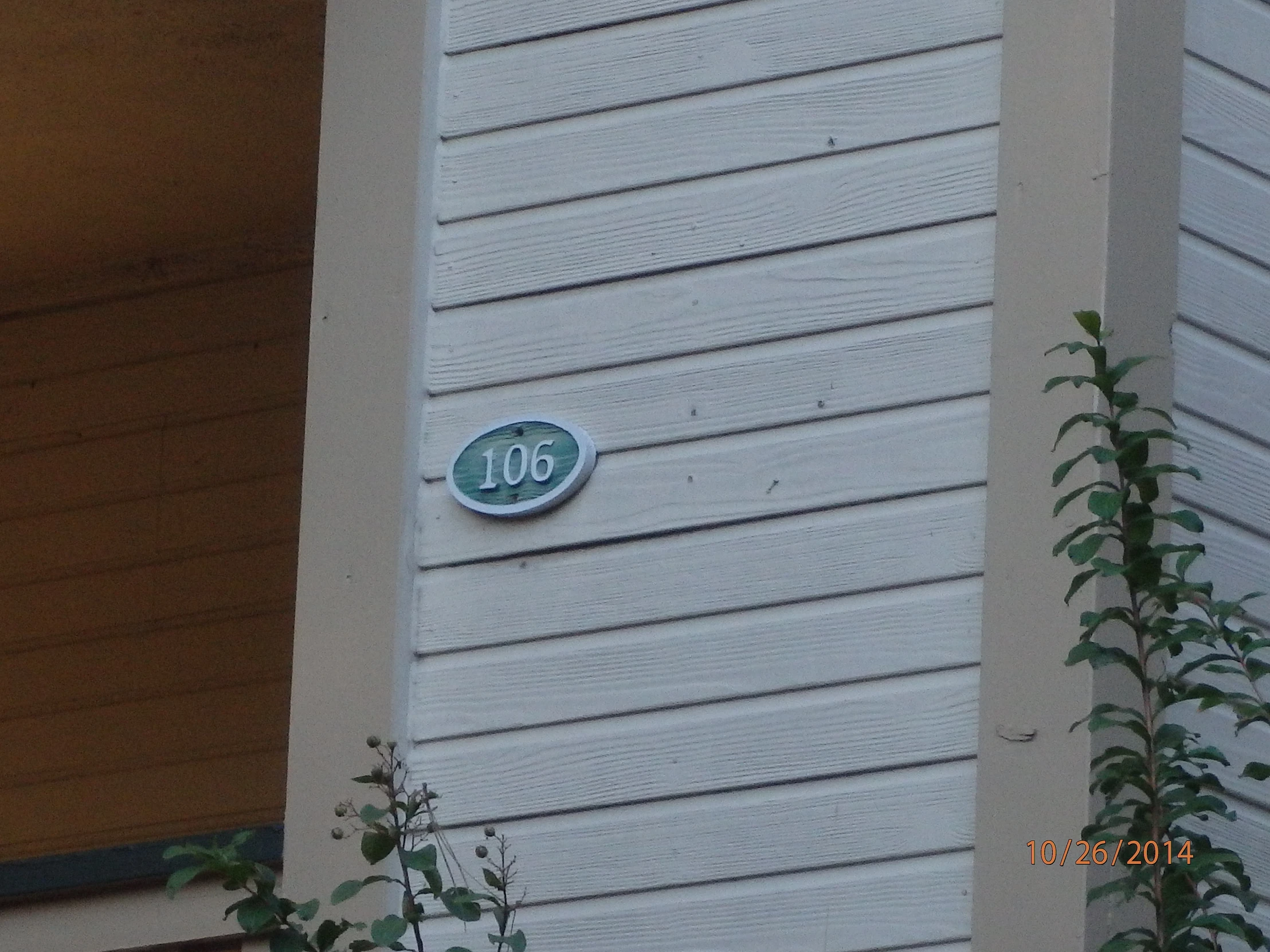 a white house with a small blue plaque on it