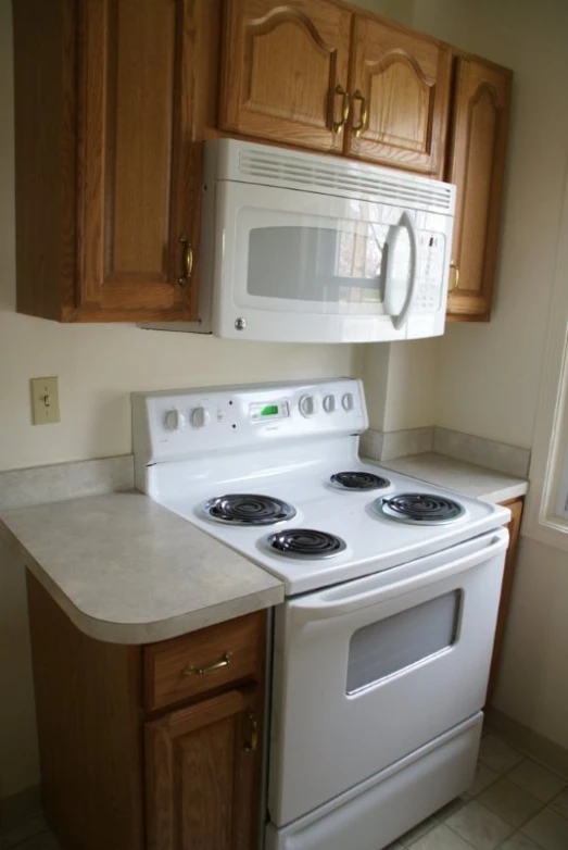 a kitchen with a stove top and a microwave
