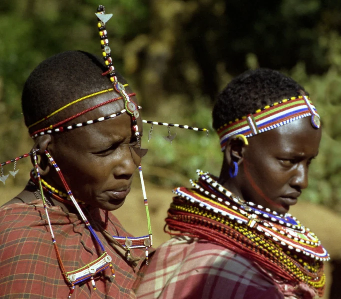 the two women are wearing very elaborate headgear