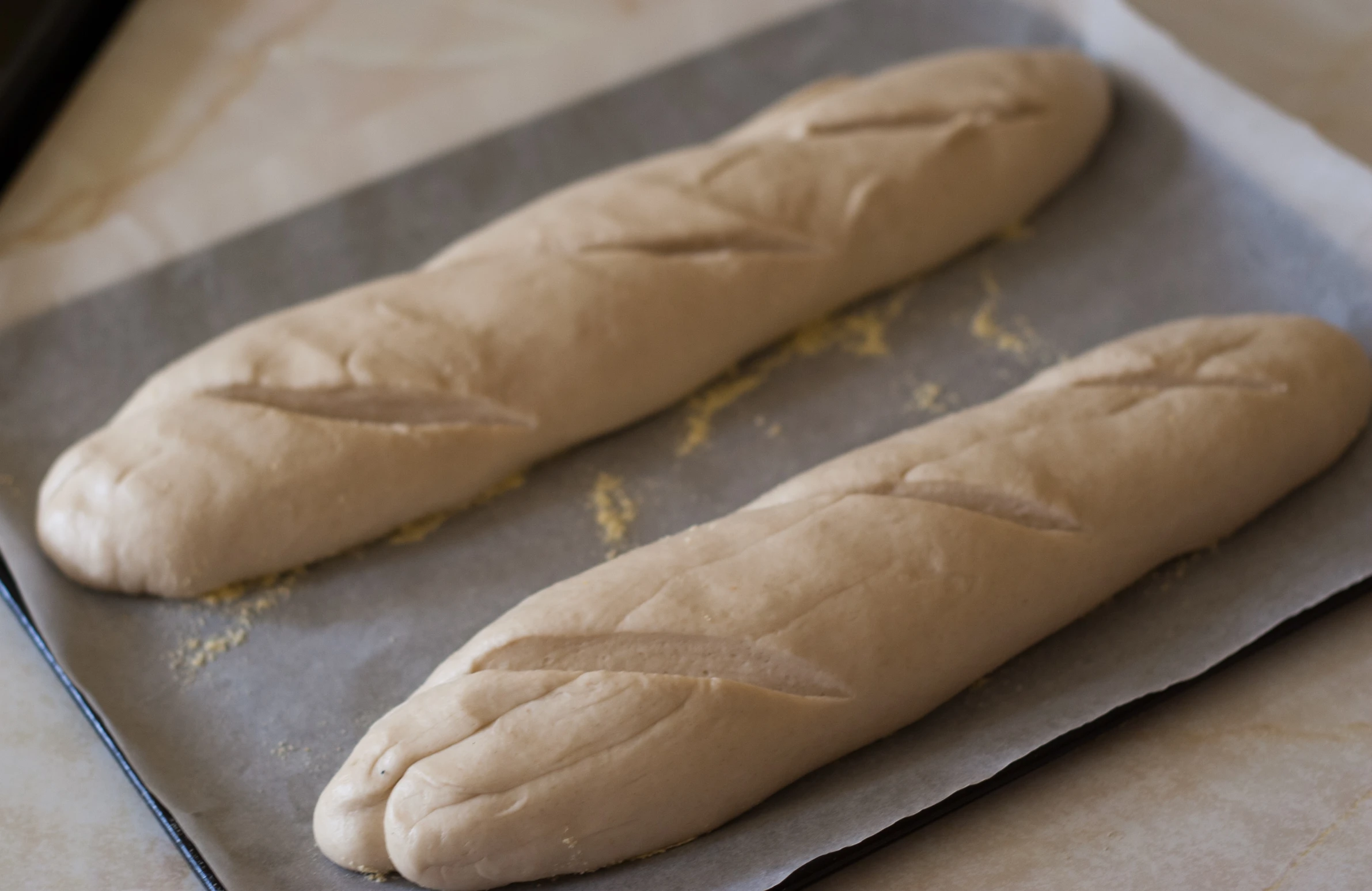 two loaves of bread sitting on a tray