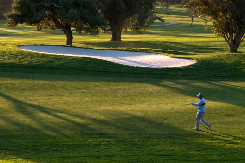 a man playing golf in a grass field