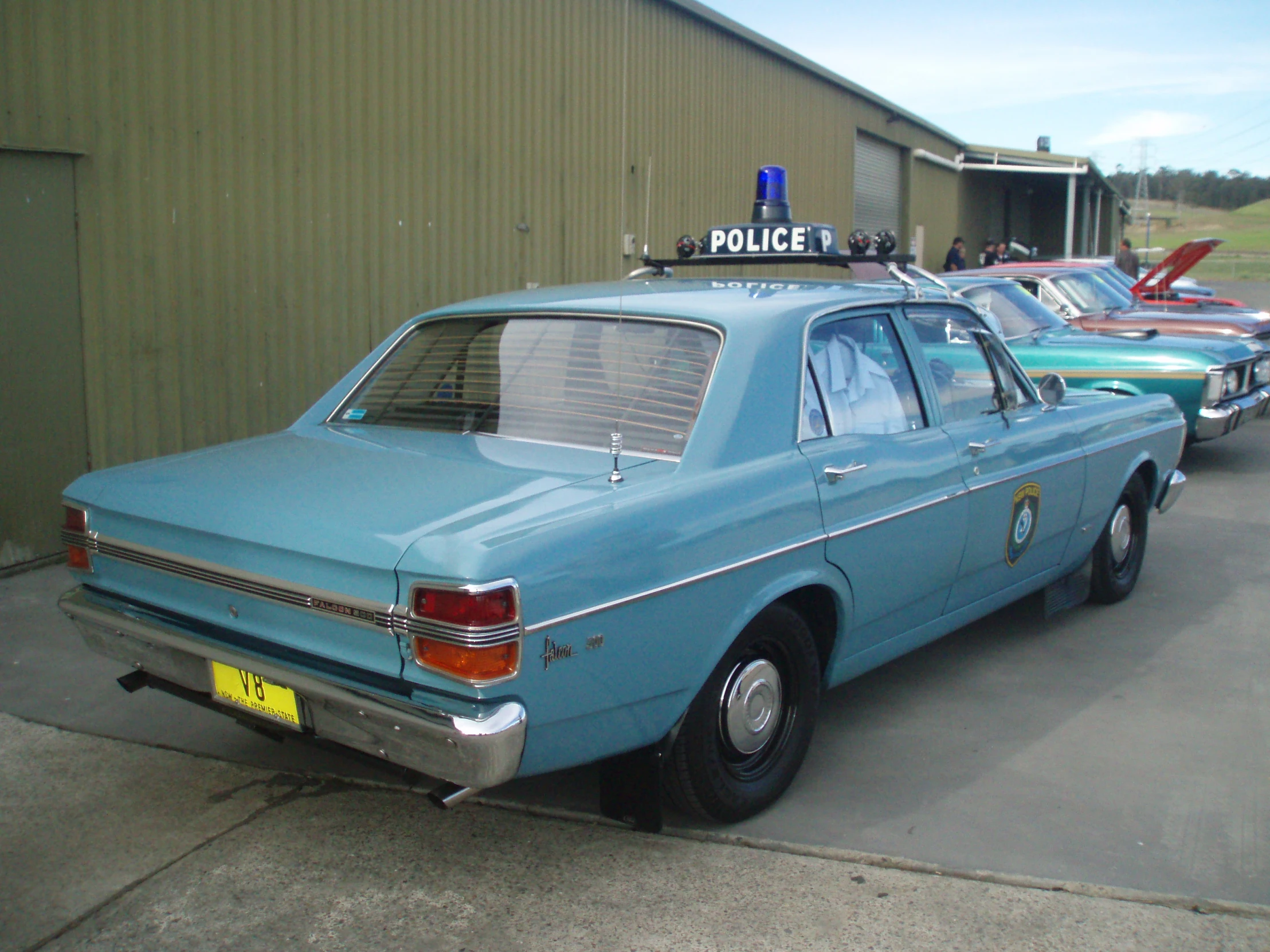 there are several old police cars that are parked together