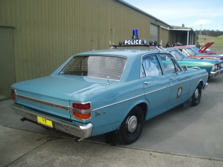 there are several old police cars that are parked together