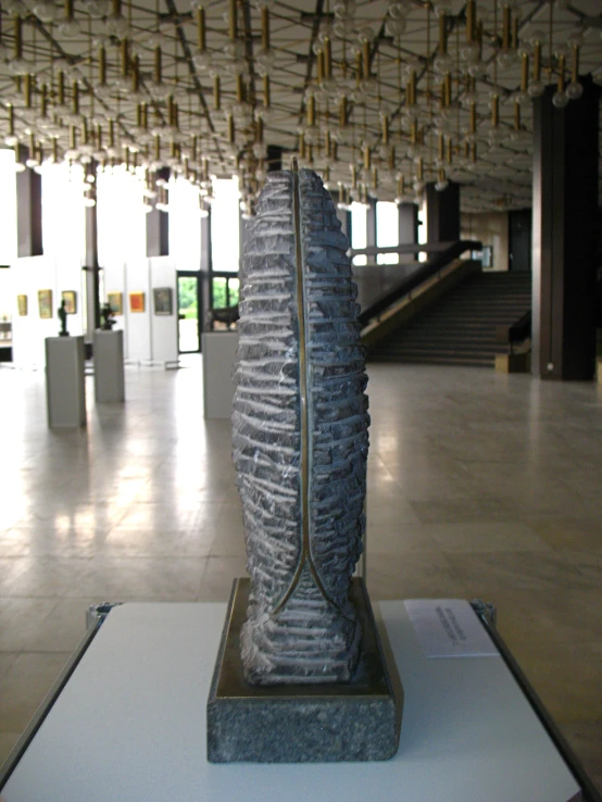 a tall vase with a curved section in the center on a table