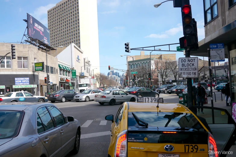 a busy city street filled with traffic next to tall buildings