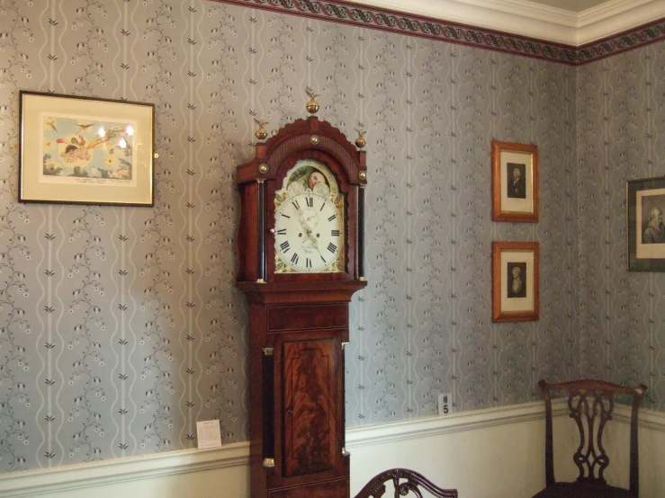 a grandfather clock sitting next to a chair