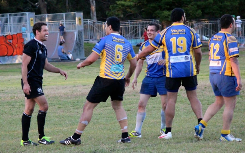 men talking together in a field during a game