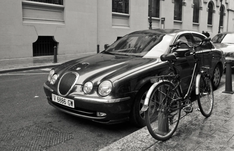 a bicycle is  to a post by a parking meter