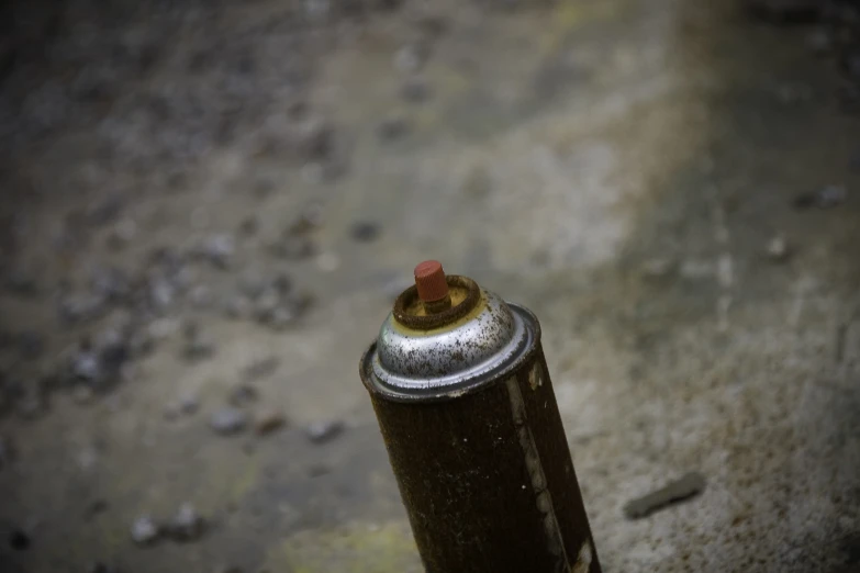 a small tin cup sits on top of a sidewalk