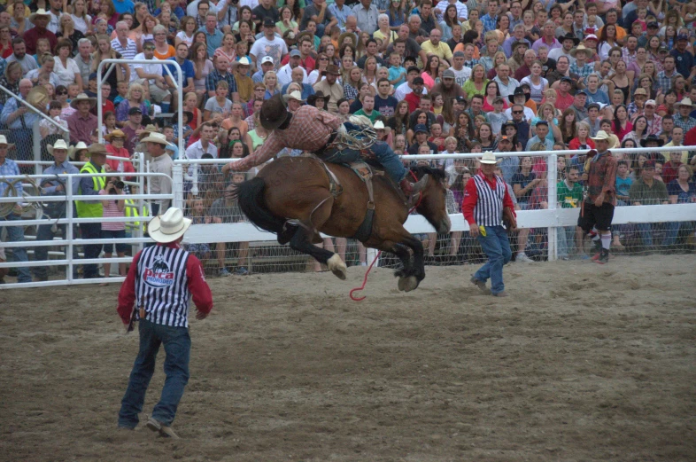 a man is in midair as he rides a horse