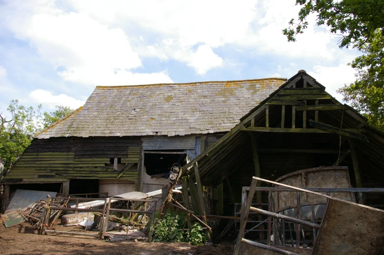 an old dilapidated and broken out house with its roof missing