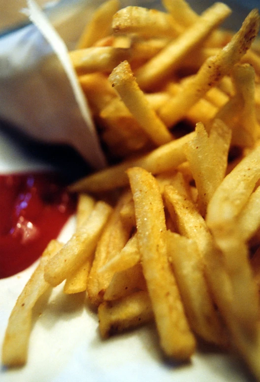 fries sitting next to ketchup and some other food