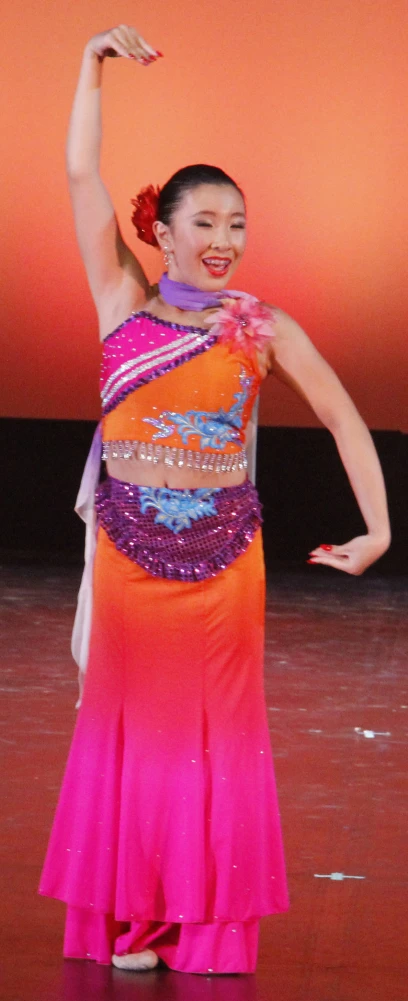 a woman wearing a colorful outfit and a head piece