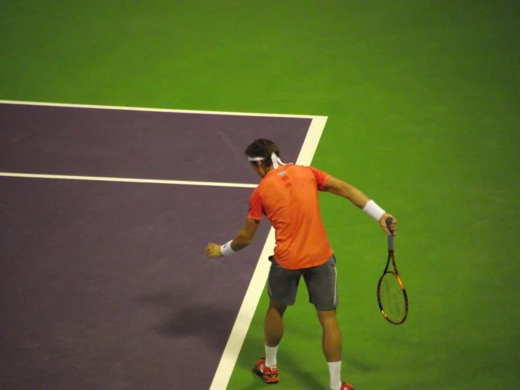 a tennis player swings his racket on a tennis court