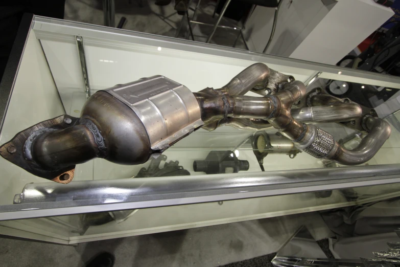 a metal pipe on display in a glass case