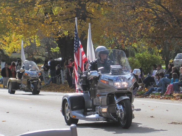 a person is riding a motorcycle with a flag on the side
