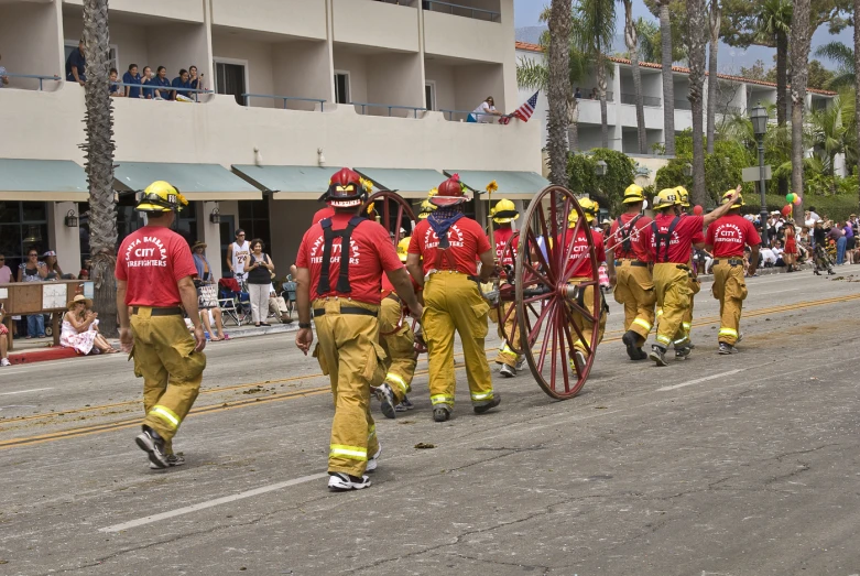 some fire fighters in red shirts and some trees