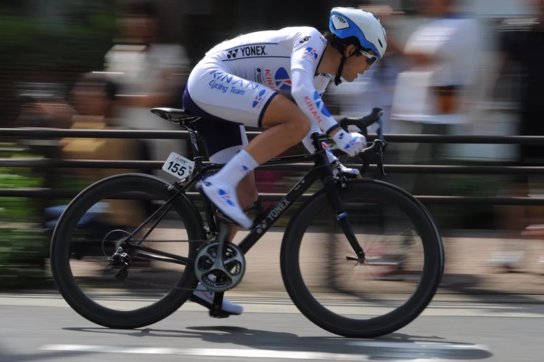 the man is racing a bike down the road