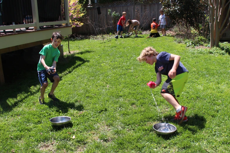 two s playing in the backyard on green grass