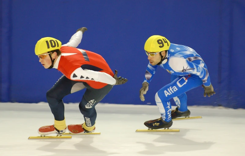 two men are competing in an ice skate competition